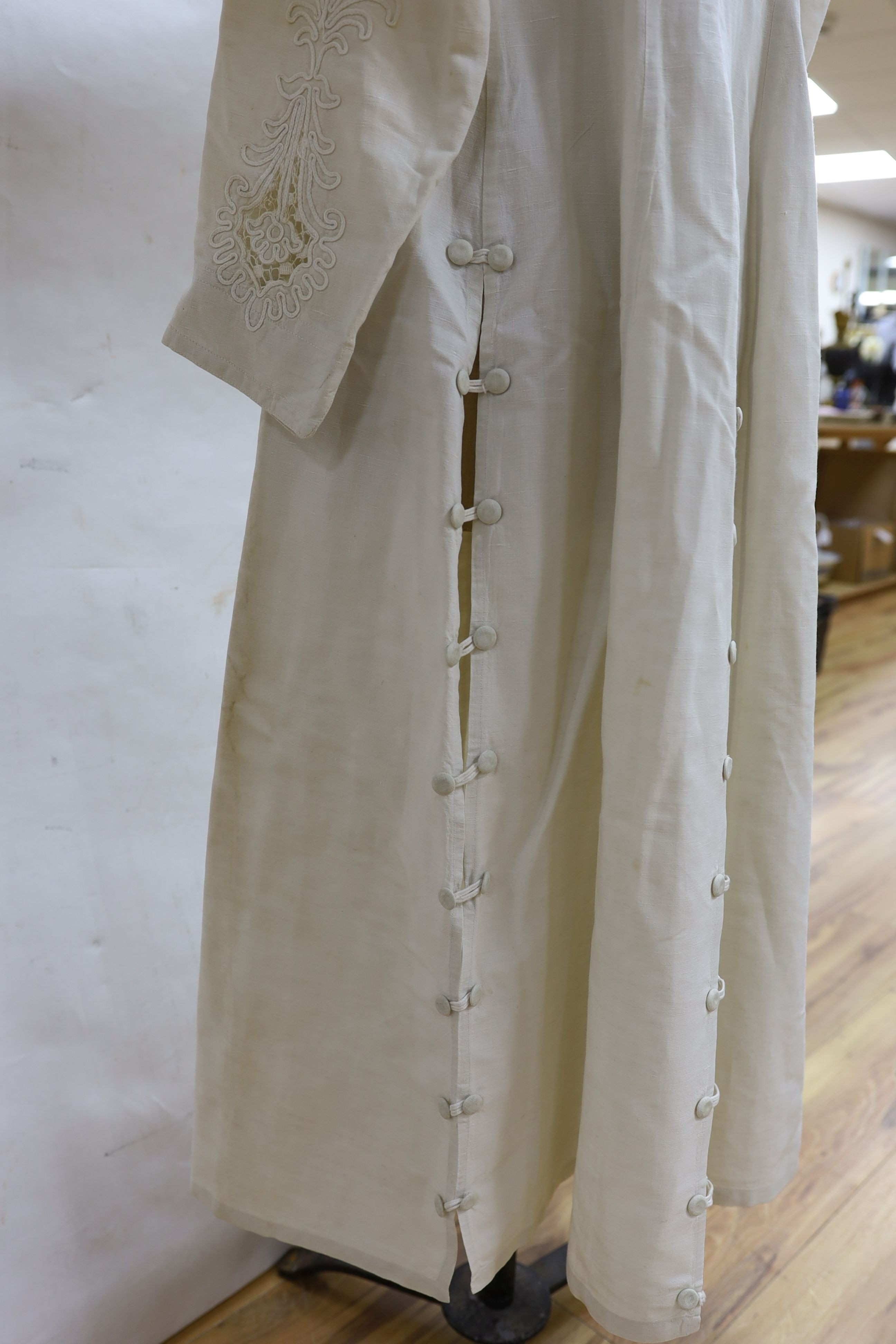 An Edwardian white/cream linen lady's coat with cut work detail and unusual button detail to the back